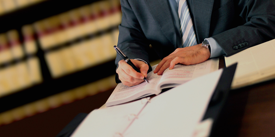 An attorney reviewing documents at a desk